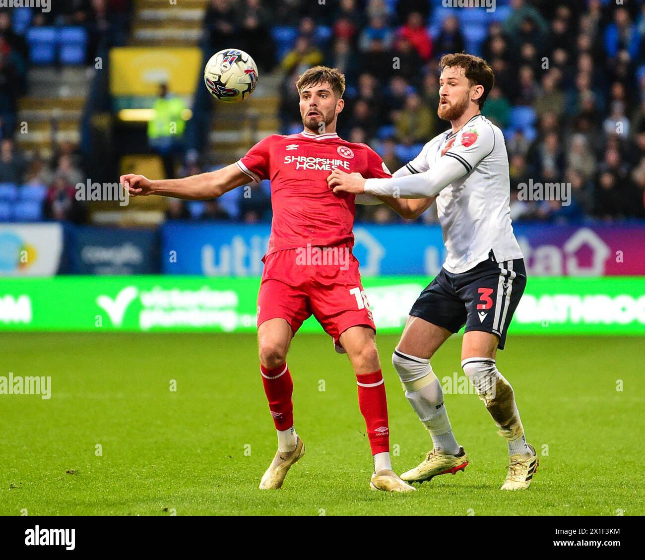 Tom Bloxham of Shrewsbury Town is challenged by Jack Iredale of Bolton Wanderers during the Sky Bet League 1 match Bolton Wanderers vs Shrewsbury Town at Toughsheet Community Stadium, Bolton, United Kingdom, 16th April 2024  (Photo by Lloyd Jones/News Images) Stock Photo