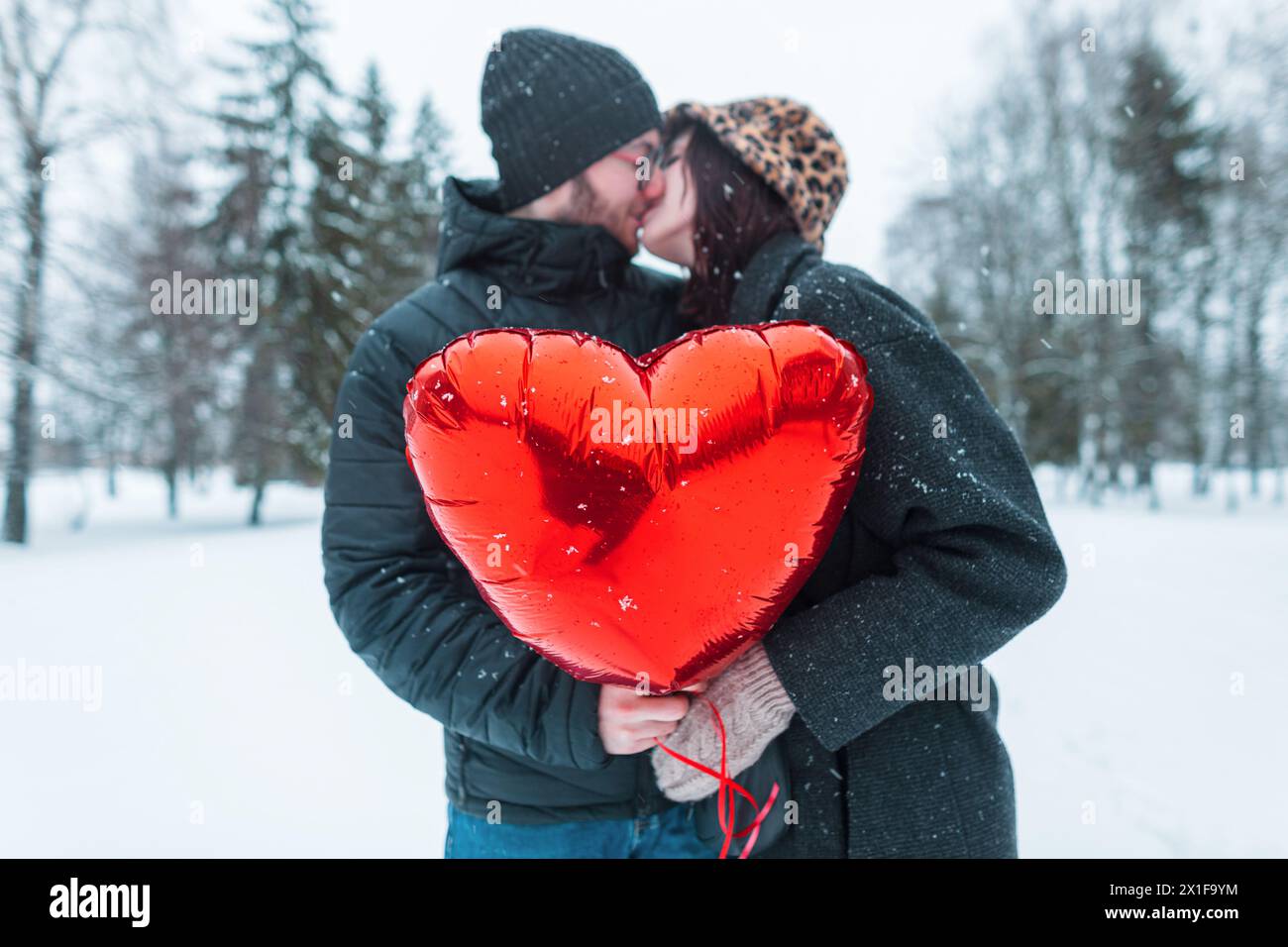 Beautiful Happy Young Couple Of Lovers Holding A Red Heart Balloon And ...