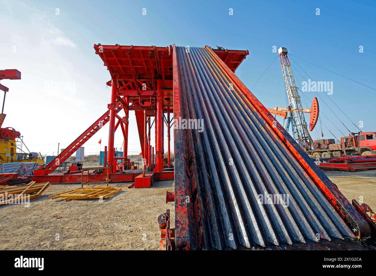 Oil pipe and oil drilling rig equipment Stock Photo - Alamy