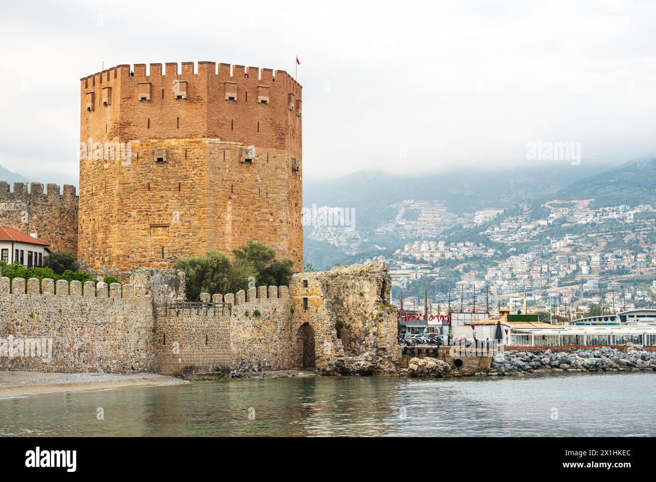The historical Red Tower in the Alanya district of Antalya, one of the touristic regions of Turkey. Turkish name Kizil Kule Stock Photo