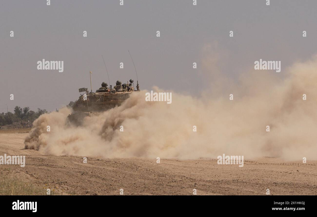 An Israeli Merkava tank rolls along the border between Israel and Gaza Strip, as it returns from central Gaza amid continuing battles between Israel and the militant group Hamas on April 16, 2024 in Gaza Border, Israel. Stock Photo
