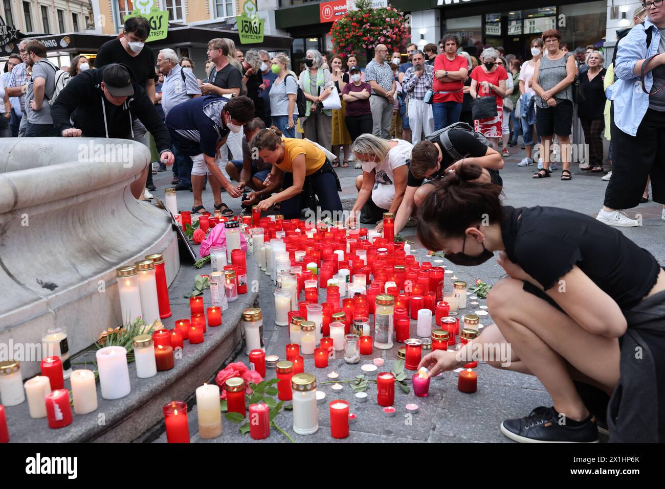 People attend a candle light memorial organised by initiative '# ...
