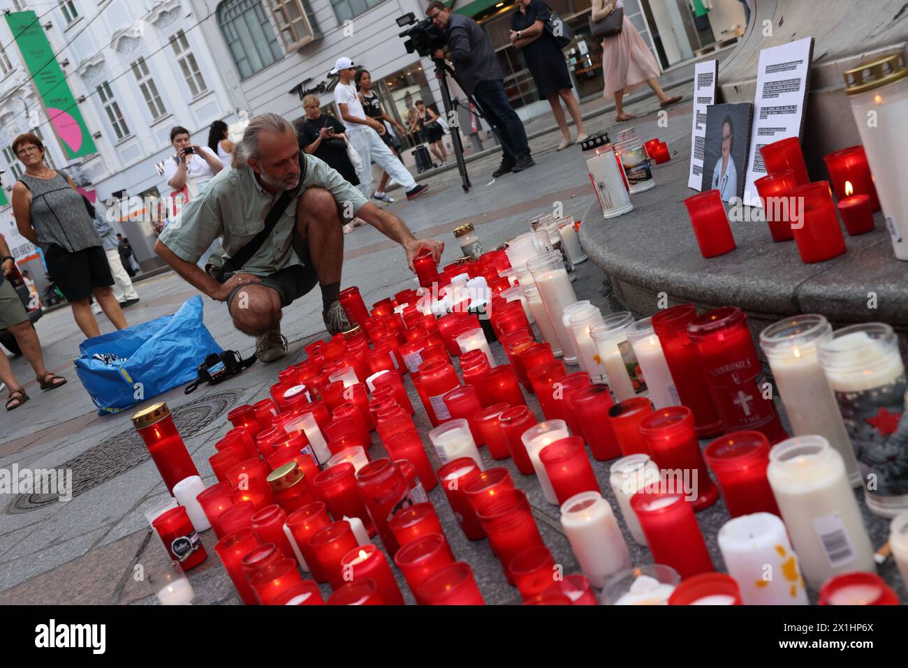 People attend a candle light memorial organised by initiative '# ...