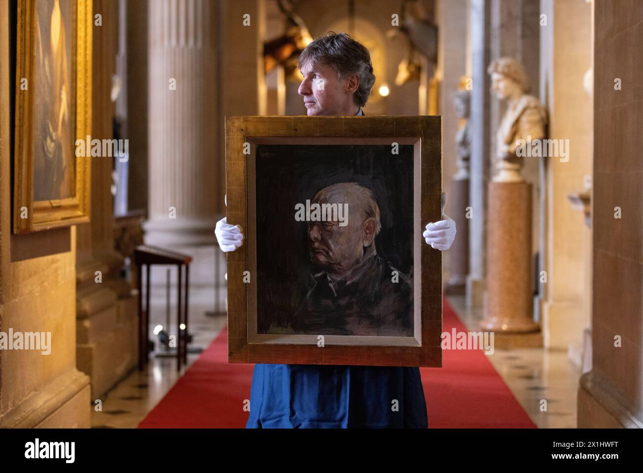 Sotheby's staff holds a portrait of the former British prime minister Winston Churchill, painted by Graham Sutherland in 1954, Blenheim Palace, UK Stock Photo