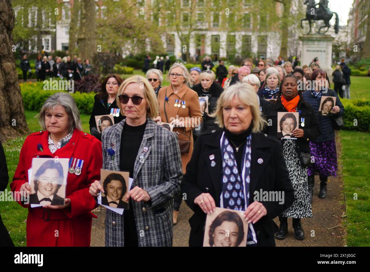 Colleagues of Pc Yvonne Fletcher hold photos of her during a procession around St James's Square, London, ahead of a 40th anniversary memorial service. Pc Fletcher was murdered on 17 April 1984 by a shot fired from the Libyan embassy in St James's Square, London, after she had been deployed to monitor a demonstration against the then Libyan leader Muammar Gaddafi. Picture date: Wednesday April 17, 2024. Stock Photo