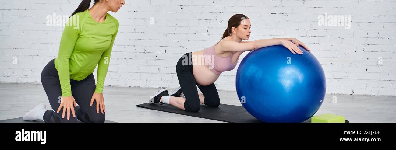 Two women, one pregnant, perform exercises on stability balls in a gym with guidance from a coach during a parents course. Stock Photo