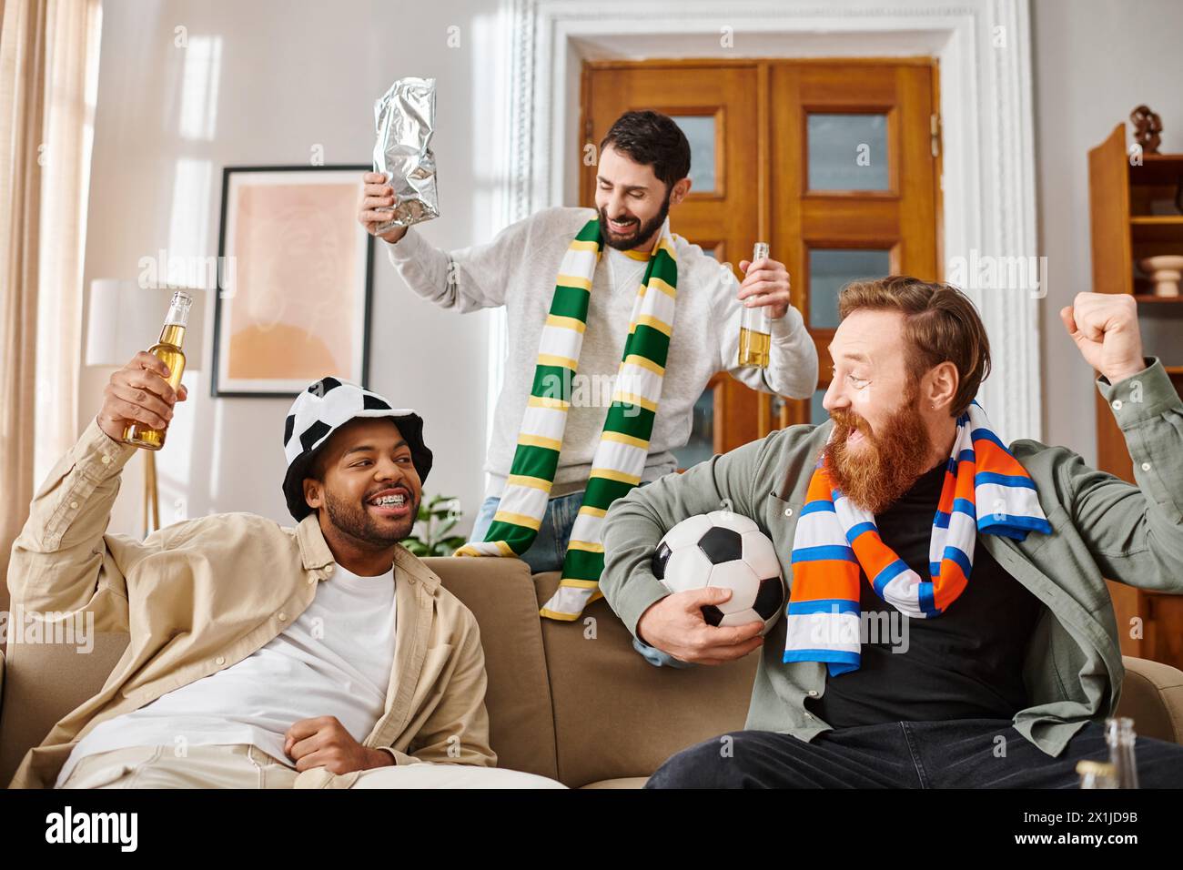 Three handsome men, different ethnicities, dressed casually, share joy atop a couch. Stock Photo