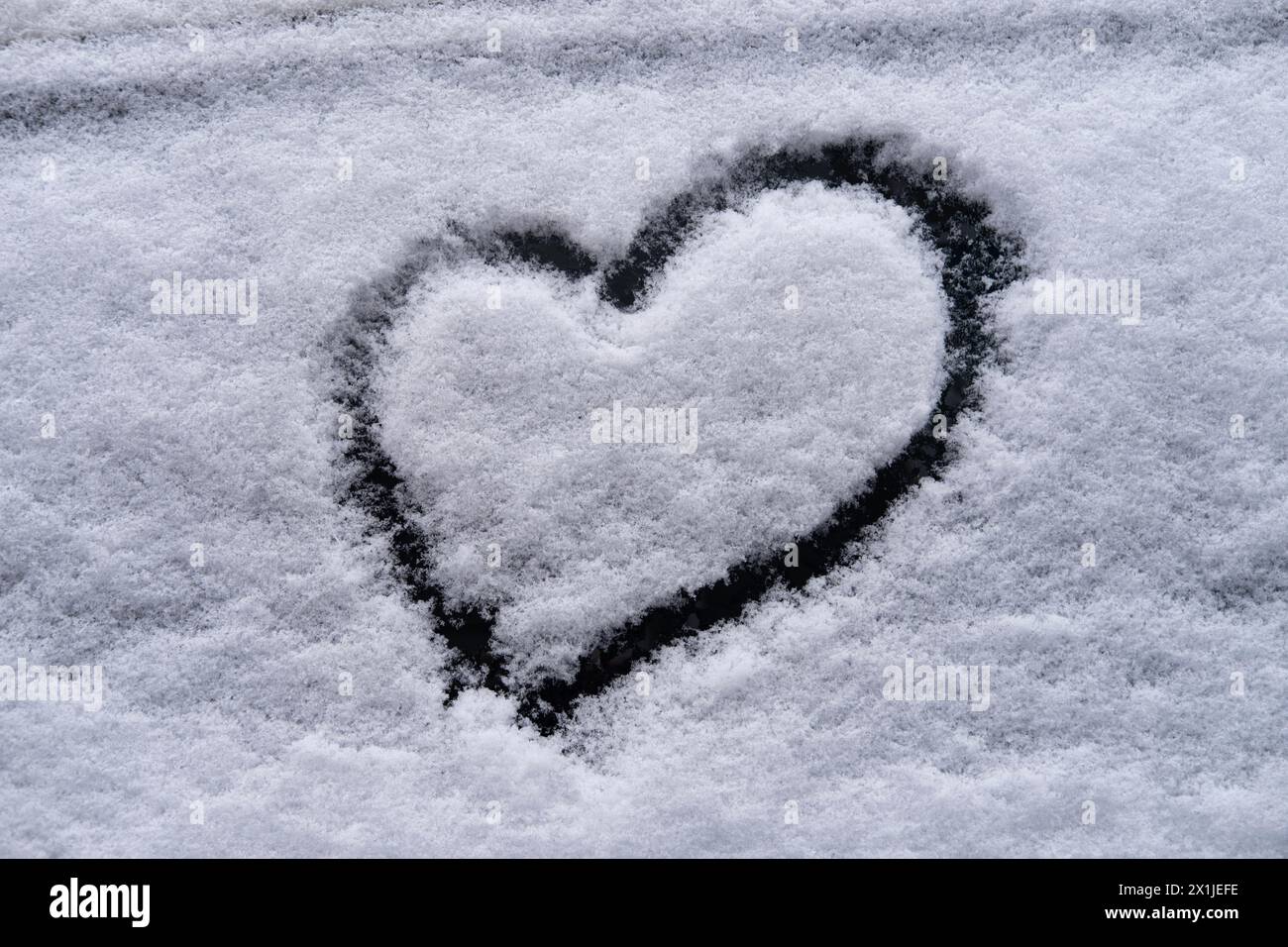 heart on snow, Valentine's Day, seasonal changes, winter weather conditions and snowfall, Nature and Environment, Atmospheric Phenomena, snowy environ Stock Photo