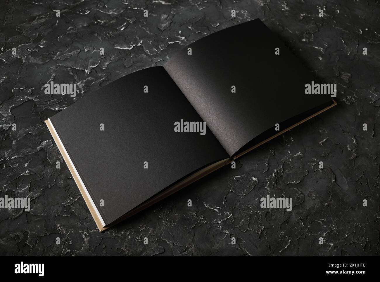 Blank black booklet on black plaster background. Responsive design template. Stock Photo