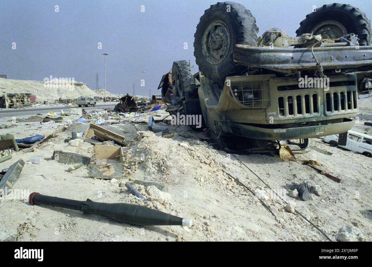 1st April 1991 An unexploded RPG-7 lies next to an upturned Iraqi ZiL-131 military truck among the devastation on the “Highway of Death”, west of Kuwait City on the main highway to Basra. Stock Photo