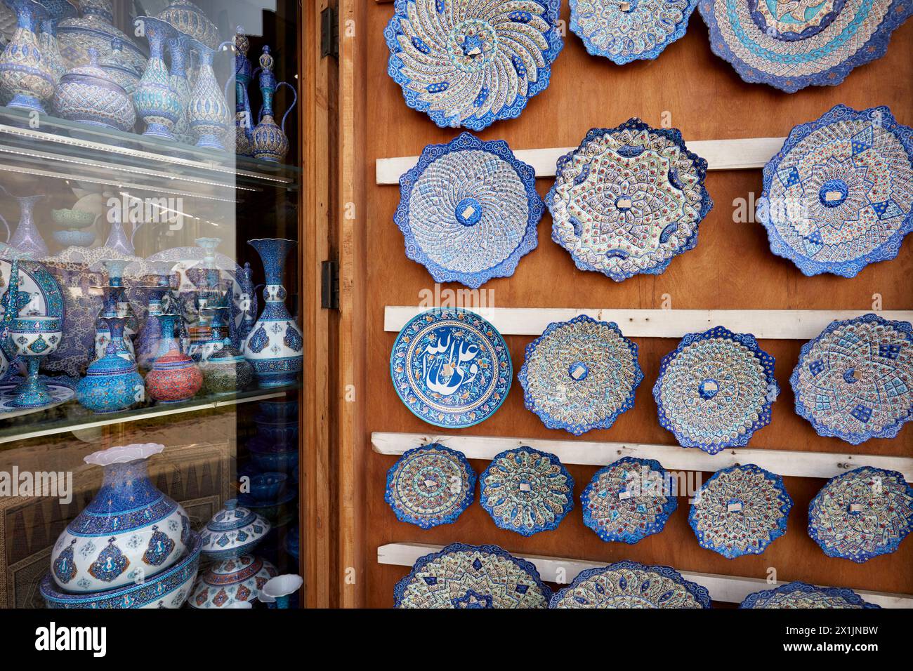 Minakari or Meenakari (Iranian of art of painting and enameling of metals or ceramics) plates displayed in a handicraft shop window. Isfahan, Iran. Stock Photo