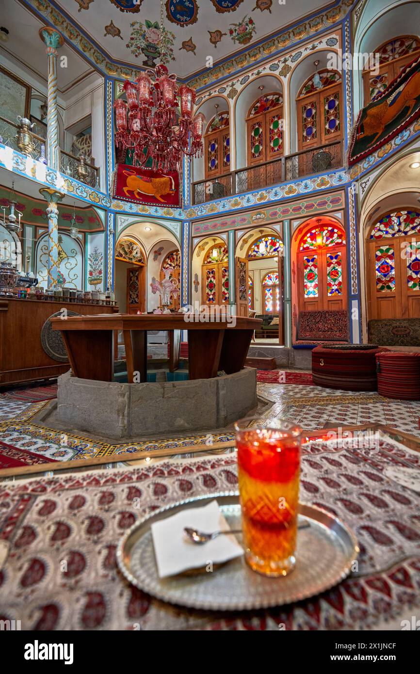 Ornate interior of a small cafe with stained glass windows in the Mollabashi Historical House. Isfahan, Iran. Stock Photo