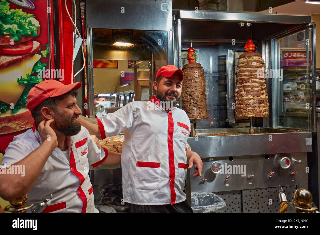 Portrait of two Iranian chefs making shawarma, traditional Middle Eastern street food, in the historic center of Isfahan, Iran. Stock Photo