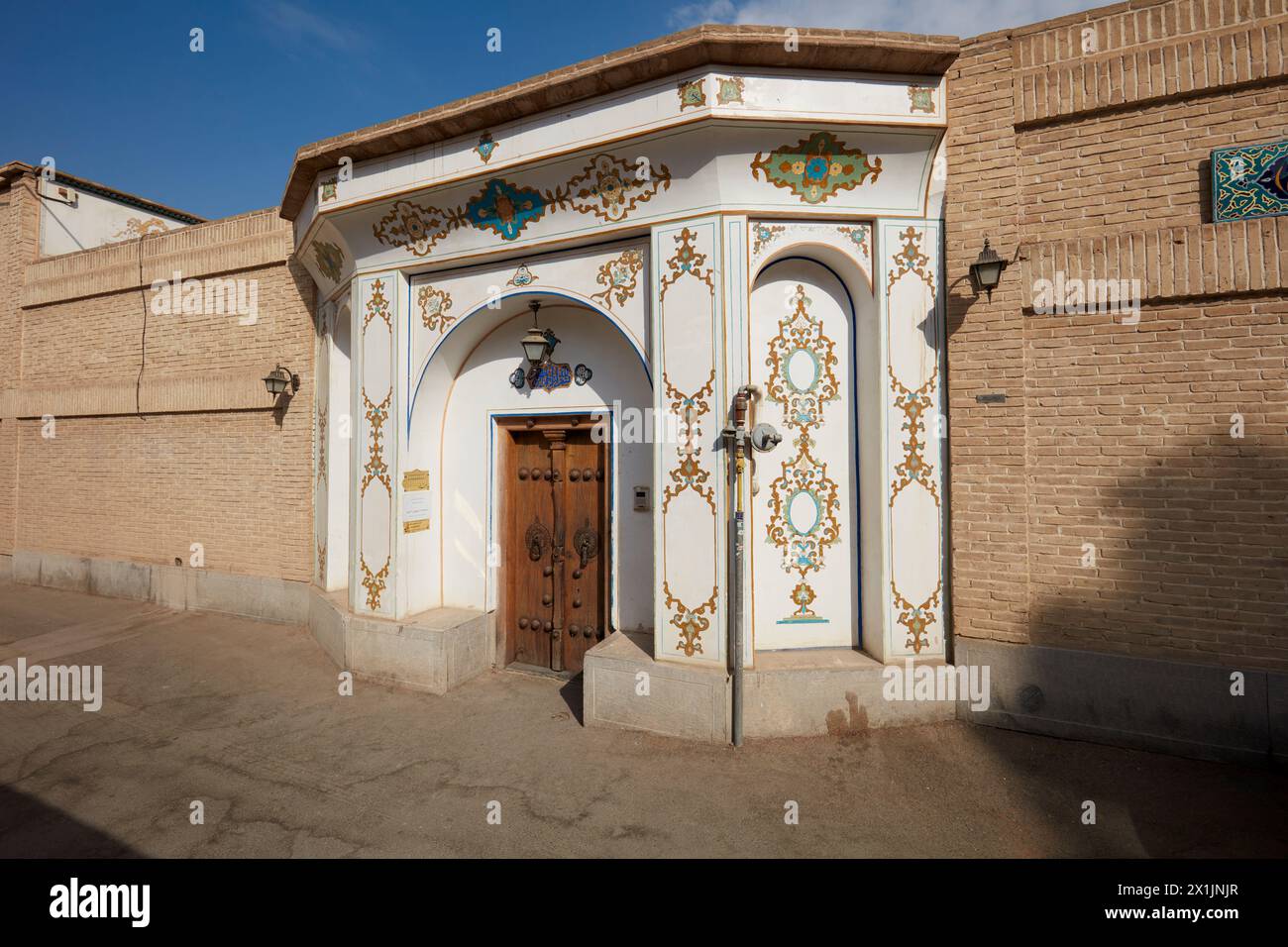 Ornate entrance gate with old wooden door of the Mollabashi Historical House in Isfahan, Iran. Stock Photo