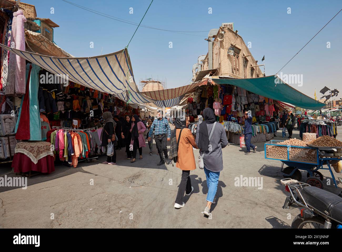 People walk in a street bazaar in the historic center of Isfahan, Iran. Stock Photo