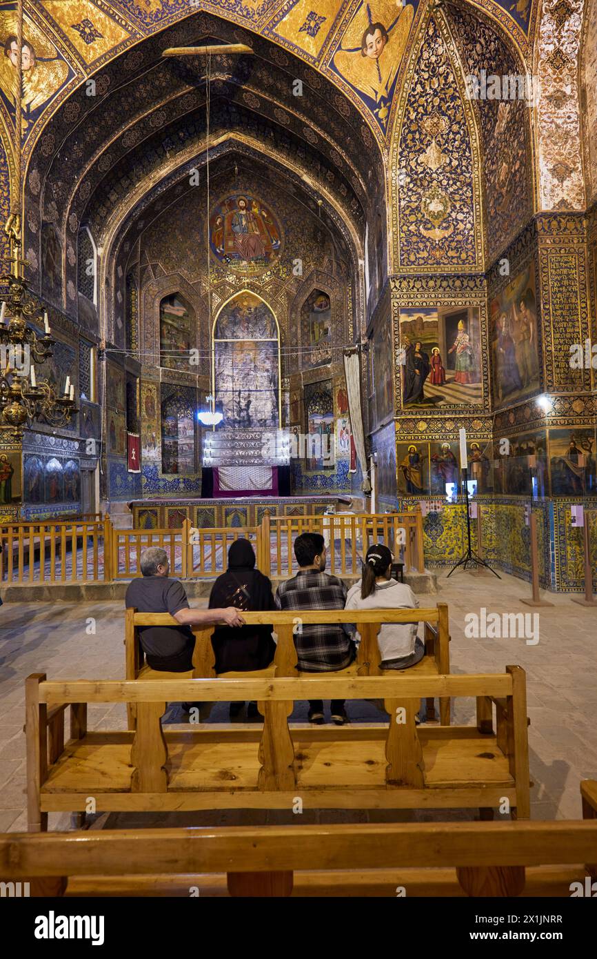 Visitors sit on a bench inside the 17th century Holy Bethlehem Church of New Julfa (Bedkhem Church), Armenian Apostolic church in Isfahan, Iran. Stock Photo