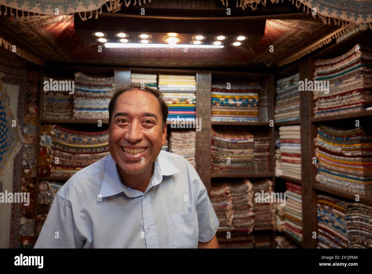 Portrait of a grinning Iranian handicraft seller who looks like once popular French comic actor Fernandel (Fernand Contandin). Isfahan, Iran. Stock Photo