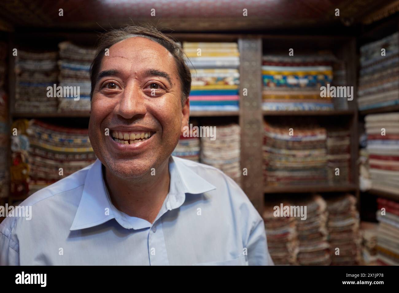 Portrait of a grinning Iranian handicraft seller who looks like once popular French comic actor Fernandel (Fernand Contandin). Isfahan, Iran. Stock Photo