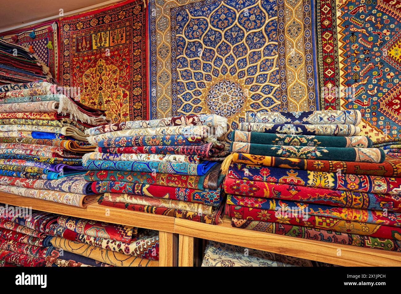 Colorful selection of handmade Persian carpets displayed in a carpet store. Isfahan, Iran. Stock Photo