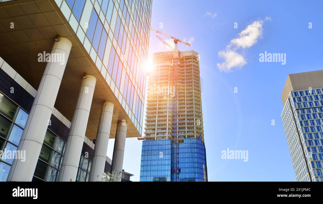 High rise building under construction. Installation of glass facade ...