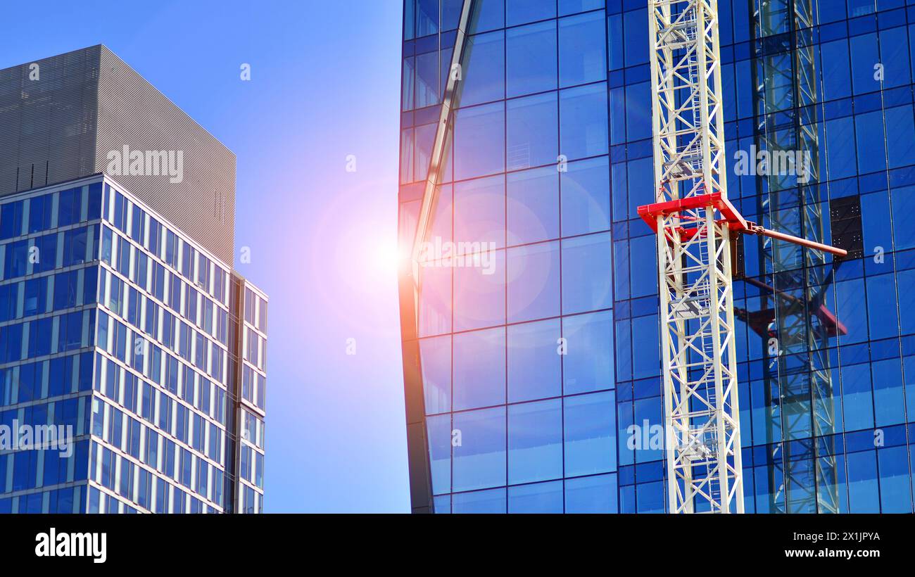 High rise building under construction. Installation of glass facade ...