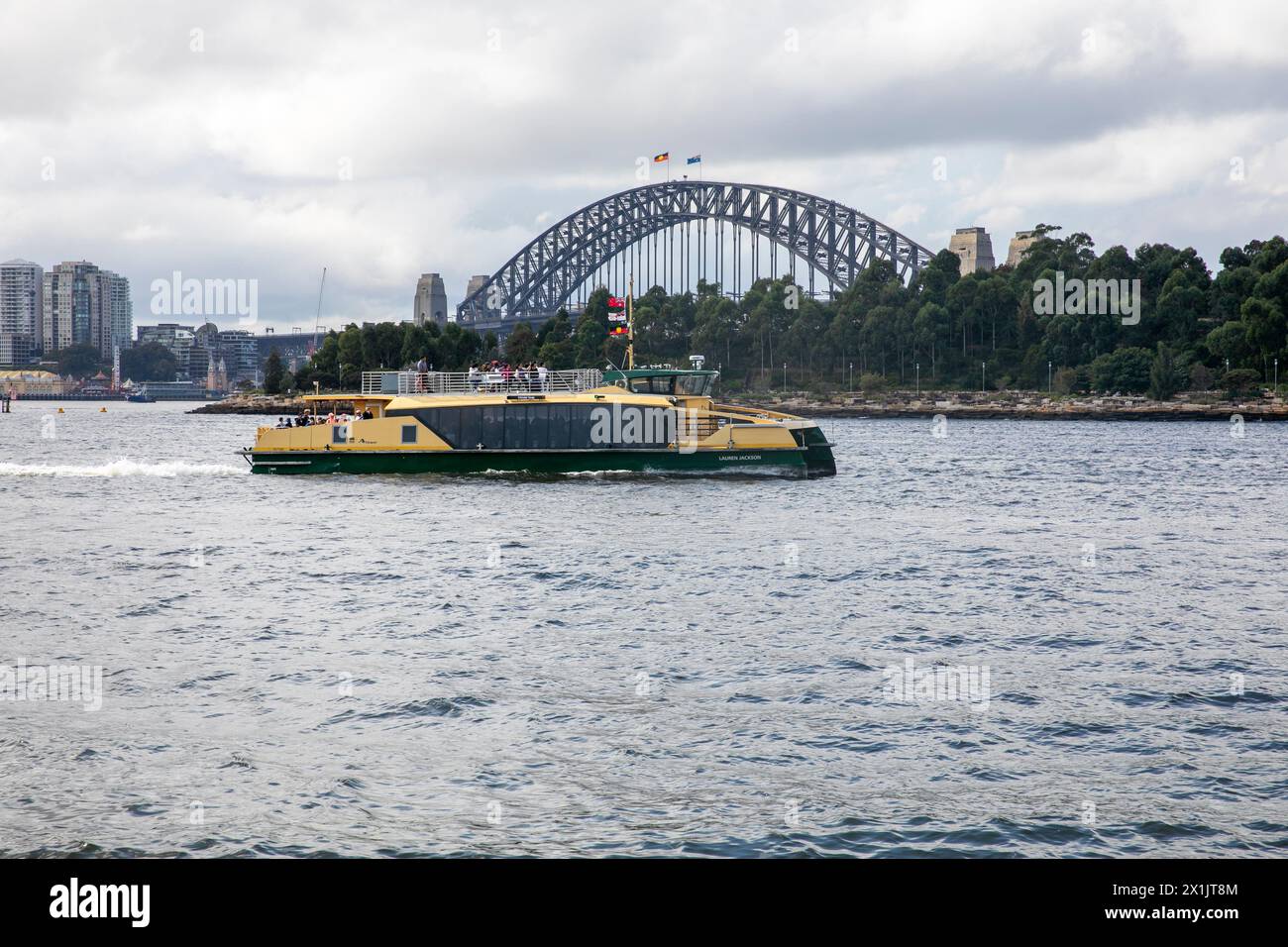 Sydney riverclass ferry the MV Lauren Jackson, named after basketball player, beside Sydney Harbour bridge and Barangaroo reserve,Sydney,Australia Stock Photo