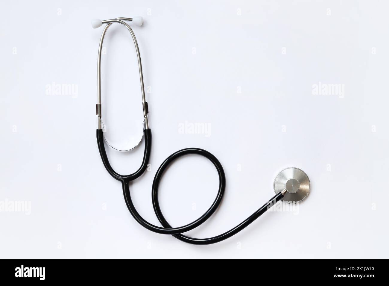 Stethoscope on a white background, top view. Medical instrument. Cardiology and medicine concept, healthcare. Auscultation device Stock Photo