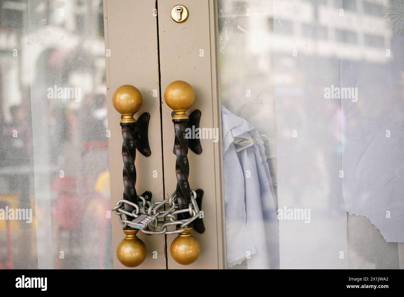 A padlock and chain on the doors of Marco Pierre White's former restaurant, Mr Whites, in Leicester Square, central London, which has reportedly been secured by police after it was occupied by squatters. Mr White's, a steak and pizza restaurant, closed in January this year. Picture date: Wednesday April 17, 2024. Stock Photo