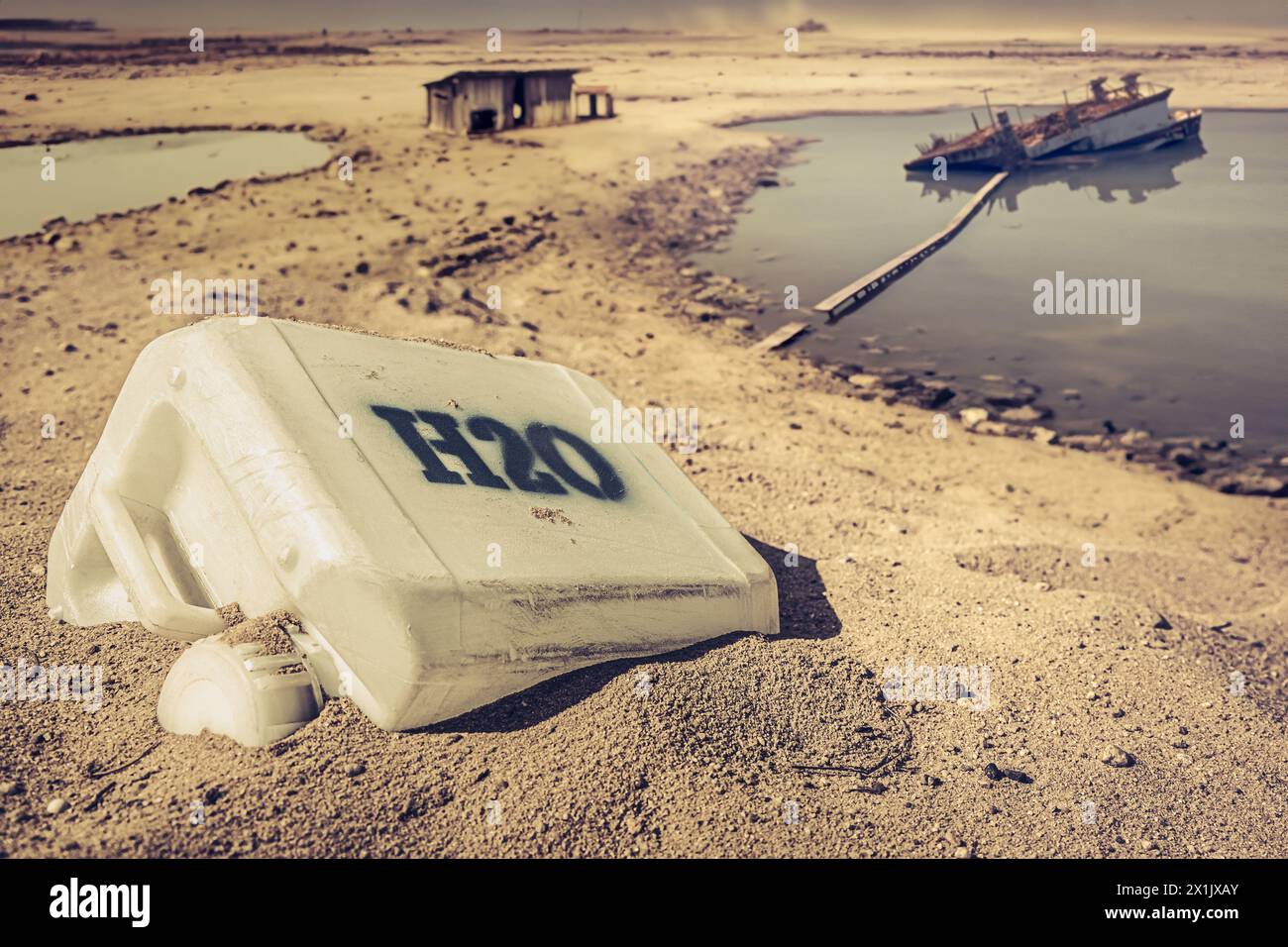 Unclean water cans in desolate and desert place. Empty plastic water cans in a desert area. Stock Photo