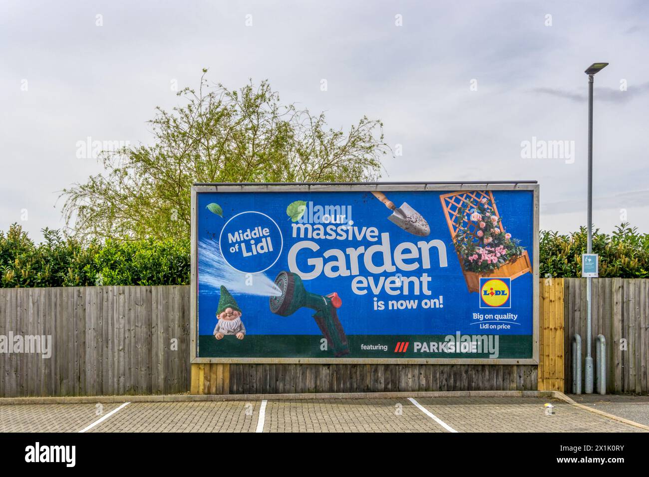 Poster advertising the Middle of Lidl - middle aisle in Lidl supermarket selling gardening equipment. Stock Photo