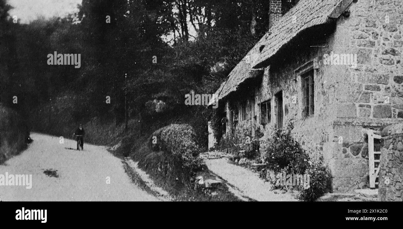 A narrow lane and a thatched house in Shorwell on the Isle of Wight. Originally printed and published for the Portsmouth and Southsea Improvement Association, c1924. Stock Photo