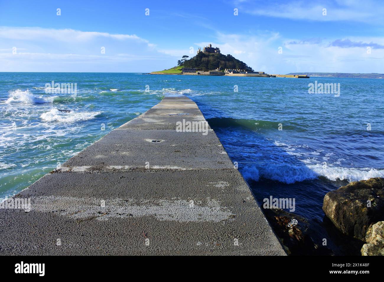 The jetty at St. Michael's Mount where visitors catch a ferry at high tide to the island - John Gollop Stock Photo
