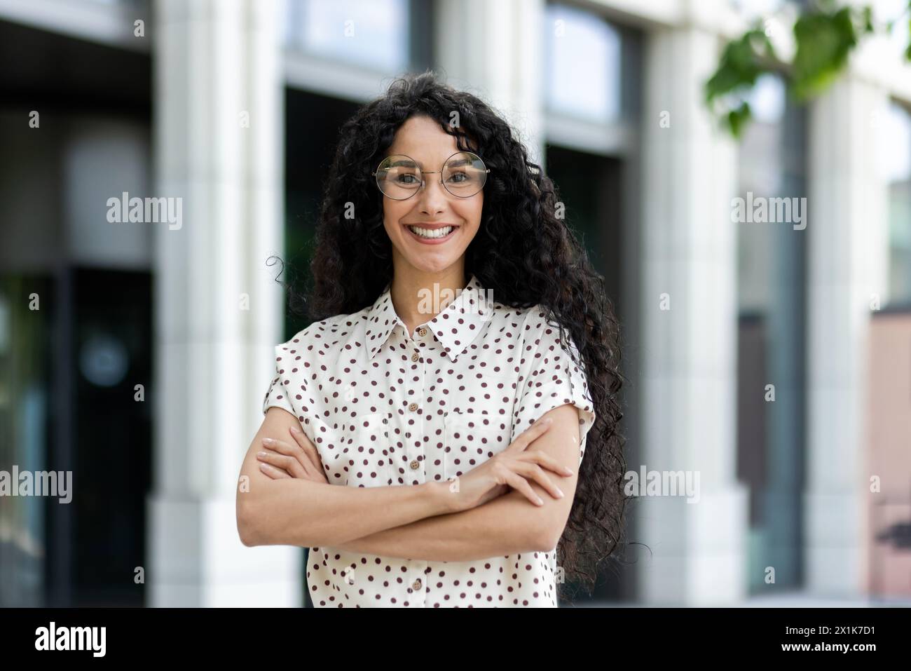 Professional and confident Hispanic woman with curly hair, wearing ...