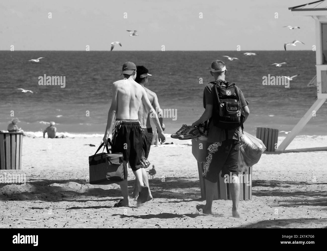 Teen Boys Carry Gear to the Beach Stock Photo