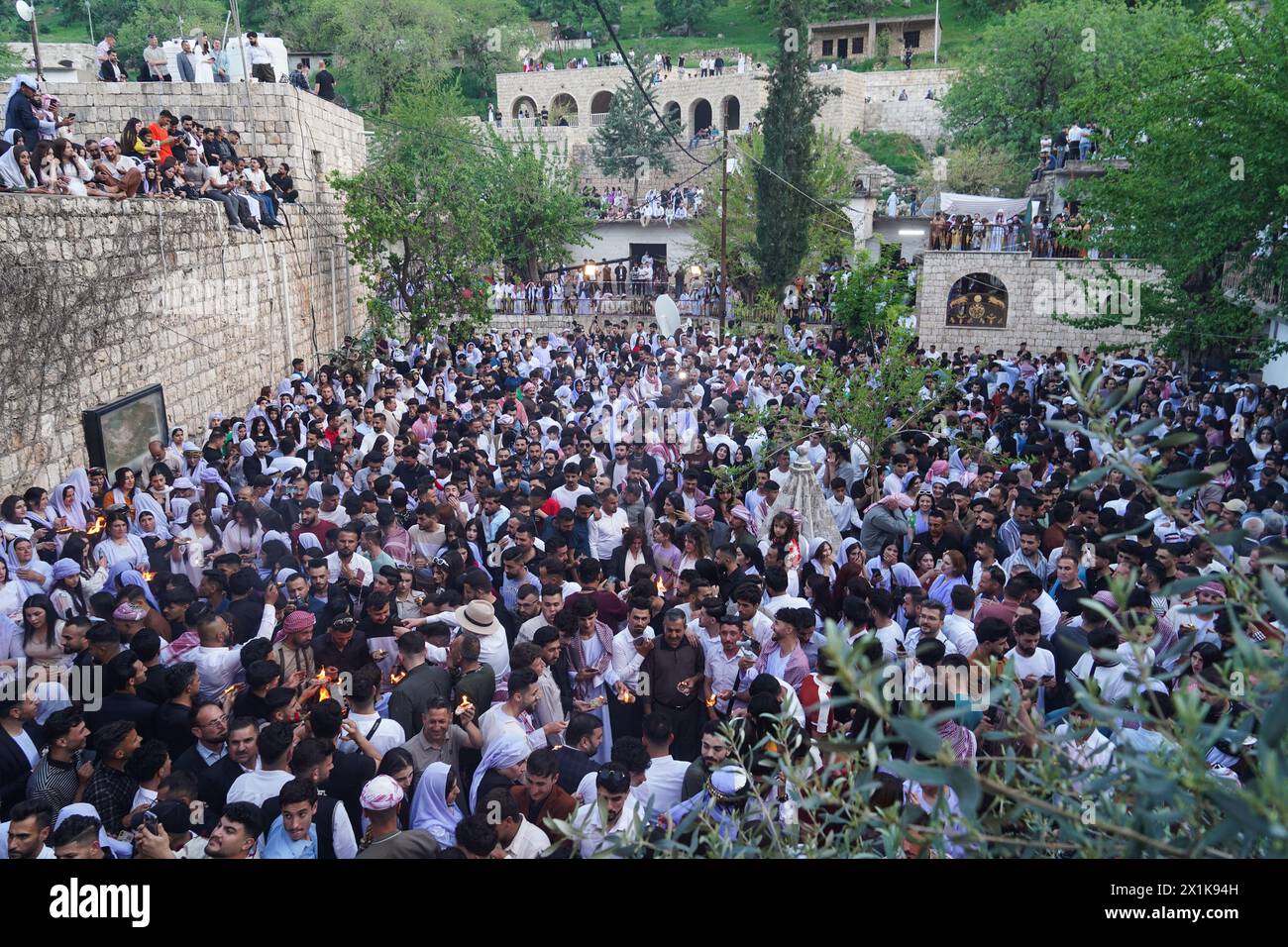 Lalish, Iraq. 16th Apr, 2024. Iraqi Yazidis gather at Lalish mountain valley and temple near the Kurdish city of Duhok, the holiest shrine of the Yazidis, during the ceremony marking the Yazidi New Year. The Yazidis, who number about 1.6 million, commemorate the arrival of light into the world during the new year celebrations. (Photo by Ismael Adnan/SOPA Images/Sipa USA) Credit: Sipa USA/Alamy Live News Stock Photo