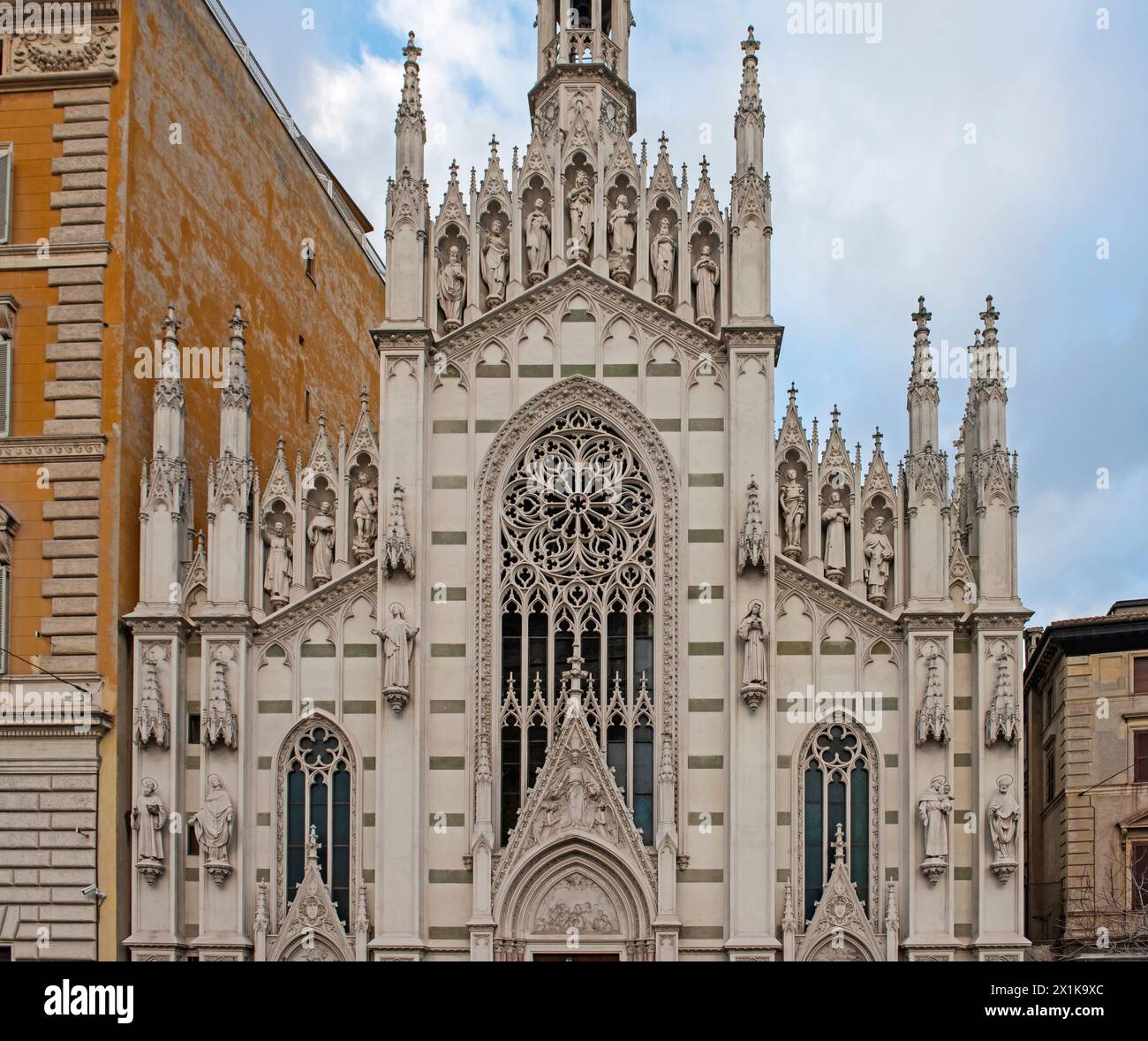 Closeup detail showing ornate exterior facade of old catholic church in rome Italy with statues and spires Stock Photo
