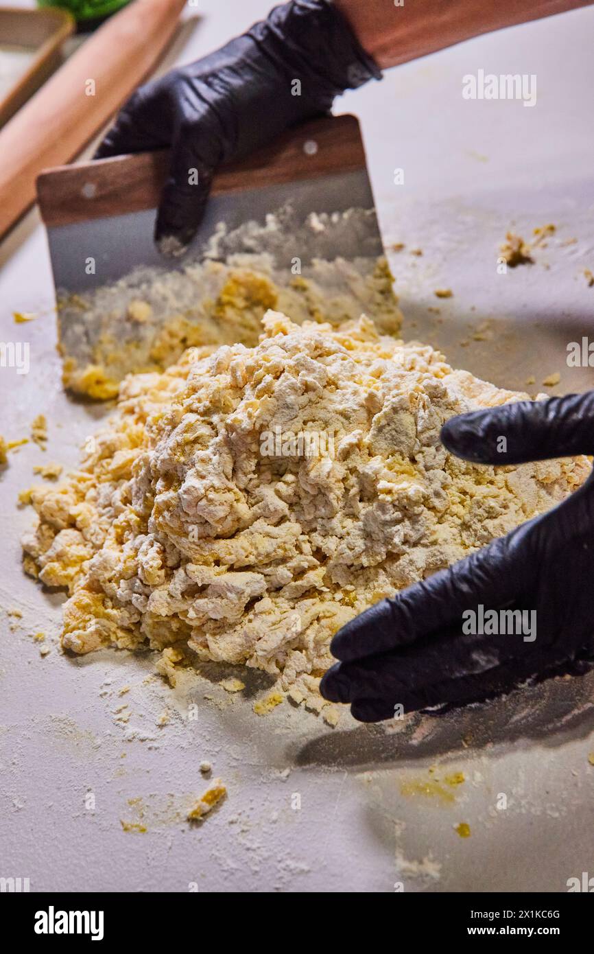 Professional Hands Kneading Pasta Dough with Scraper, Slight Angle View Stock Photo