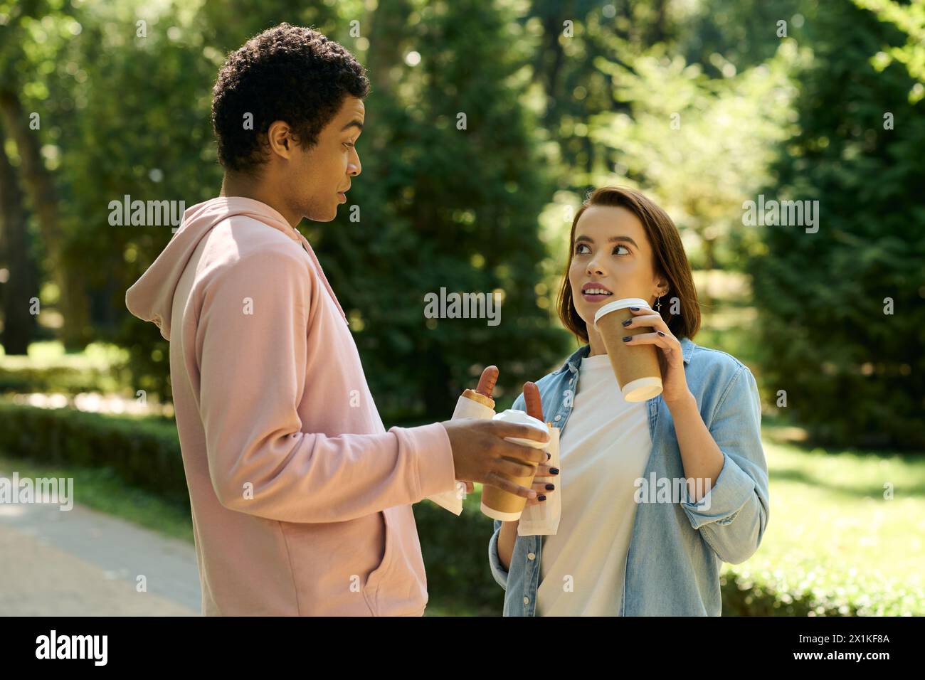 A couple in vibrant attire engages in a lively conversation outdoors ...