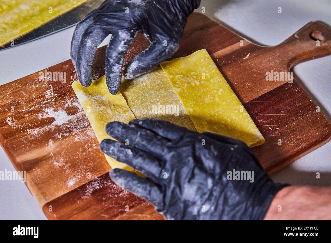 Artisan Pasta Making with Hygienic Gloves, Close-Up Perspective Stock Photo