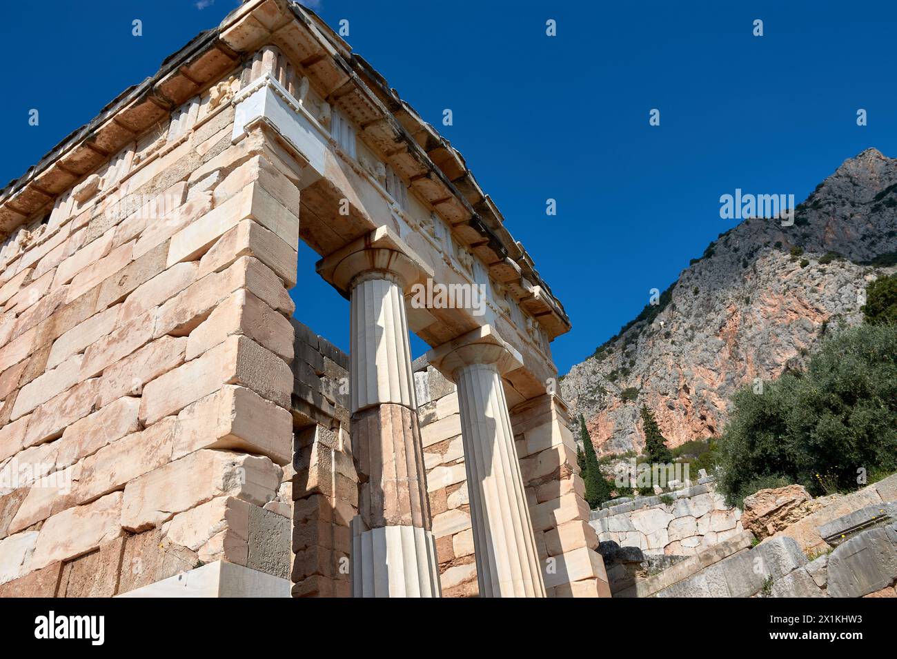 The Treasury of Athens or Athenian Treasure in Delphi. Delphi is ancient sanctuary that grew rich as seat of oracle that was consulted on important de Stock Photo