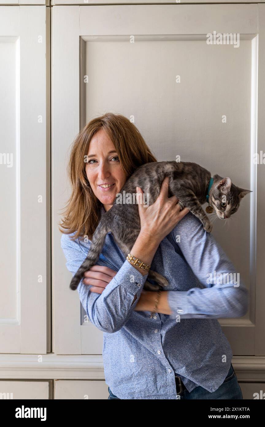 Portrait or homeowner with pet cat inside Greenwich flat, London, UK Stock Photo