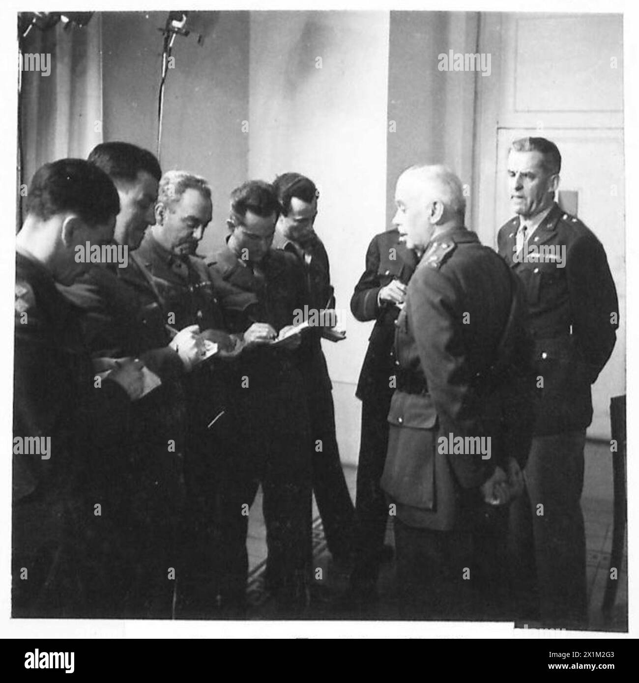 ALLIED FORCE HEADQUARTERS : ITALY UNCONDITIONAL SURRENDER - Lieutenant General W.D. Morgan (hands clasped) addresses the Press just after the short nine minute meeting of German and Allied Forces representatives that culminated in the unconditional surrender of all German Forces in Italy and Western Austria to the Allies. Presenting the Press, from left to right, are:- Lieut.W.R. Taylor, Union Jack Patrick Smith, B.B.C. Hubert Harrison, Reuter Howard Taubman, Stars & Stripes Winston Burdett, C.B.S. (obscured) Herbert King, United Press Brigadier General A.J. McChrystal, Chief Information, News Stock Photo
