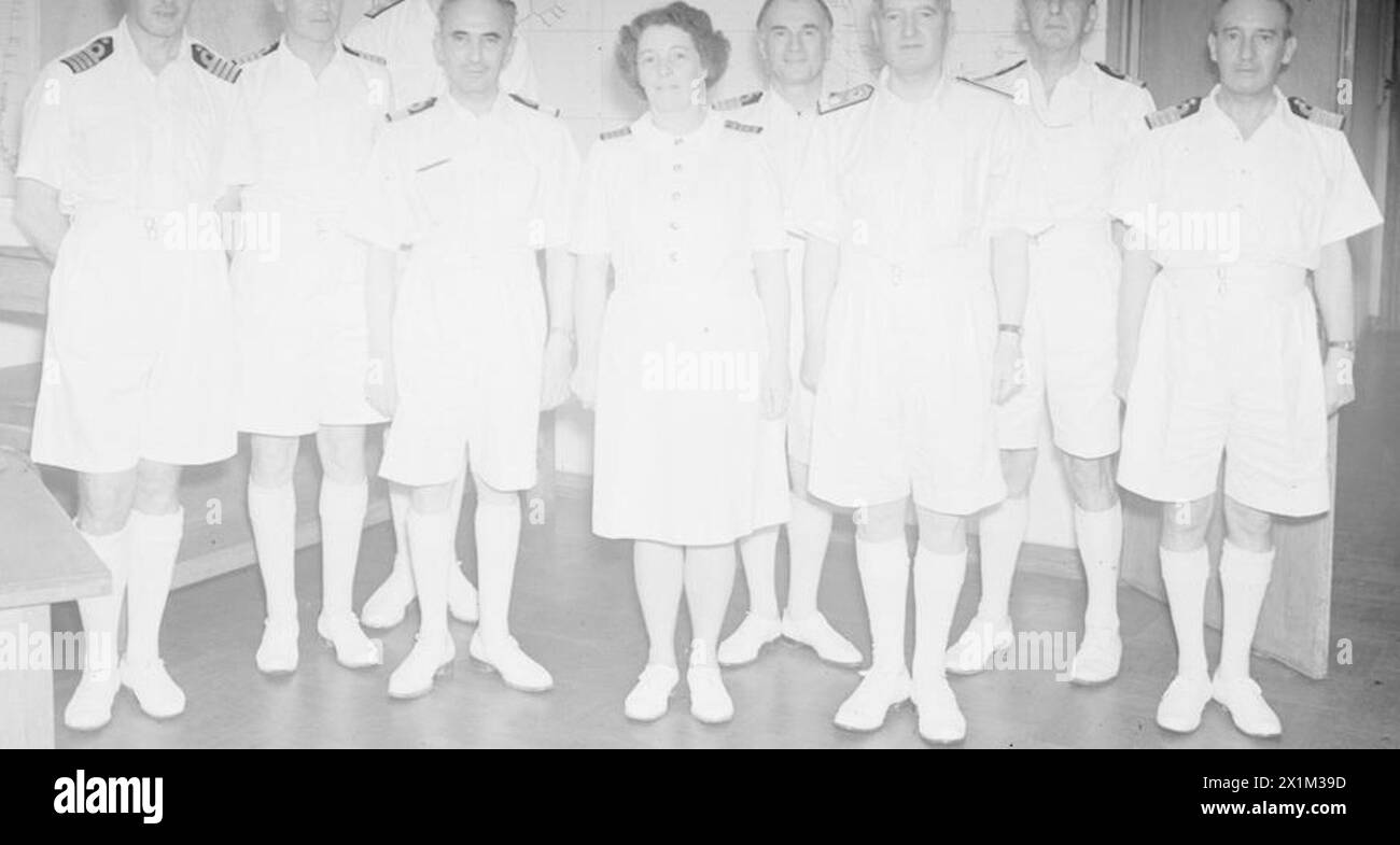NEW EASTERN C IN C MEETS HIS STAFF. 23 AUGUST 1944, COLOMBO CEYLON. ADMIRAL SIR BRUCE FRASER, GCB, KBE, INTRODUCED TO HIS OPERATIONAL STAFF. - Admiral Sir Bruce Fraser with his senior staff officers. Left to right: Acting Instructor Captain Kelly, BSc, RN, Surgeon Captain (D) F R P Williams, RN; Commodore E M Evans-Lombe; Commodore D de Pass; Acting Superintendent Miss J T Kidd, WRNS; Surgeon Captain K A I McKenzie, RN; Admiral Sir Bruce Fraser, GCB, KBE; Commodore A R Hammick; Paymaster Captain A G Bath, RN, Stock Photo