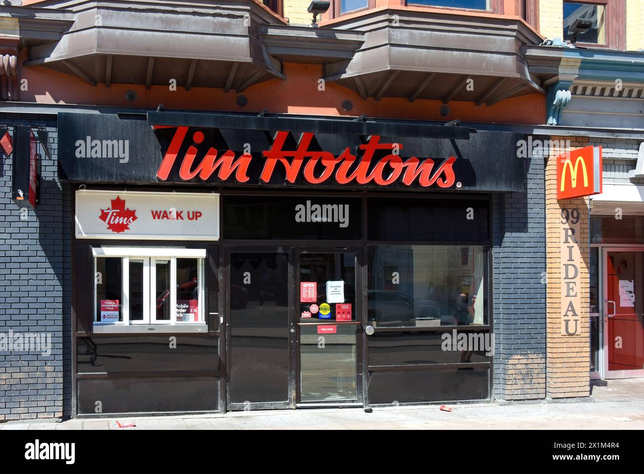Ottawa, Canada - April 16, 2023: Tim Hortons on Rideau Street offer customers an option to order and pick up coffee and goods through a walk up window Stock Photo