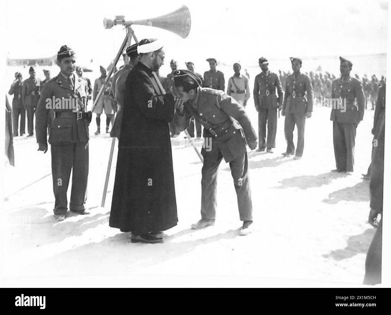Officers of a Libyan battalion salute Sayed As Senoussi during his ...