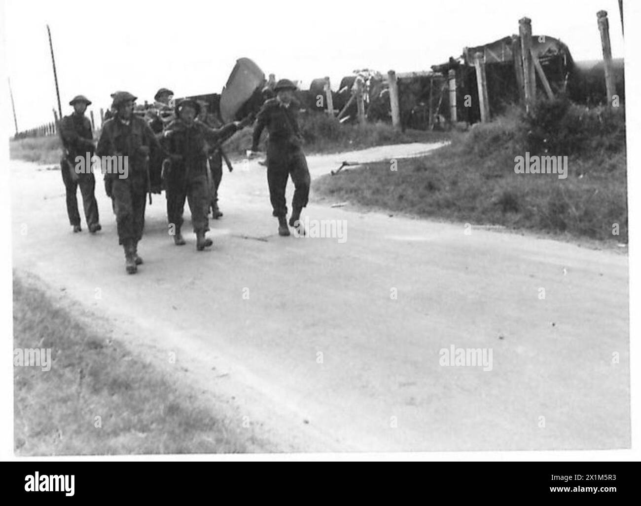 D-DAY - BRITISH FORCES DURING THE INVASION OF NORMANDY 6 JUNE 1944 - Royal Engineers with their kit in a cart pass a crashed Horsa glider of 6th Airborne Division near Ranville, on the evening of 6 June 1944, Stock Photo
