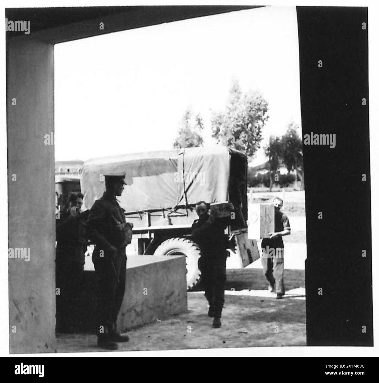 NAAFI SUPPLIES FOR FRONT LINE UNITS - Supplies brought by lorry from the coast, being unloaded from a lorry at the depot, British Army Stock Photo