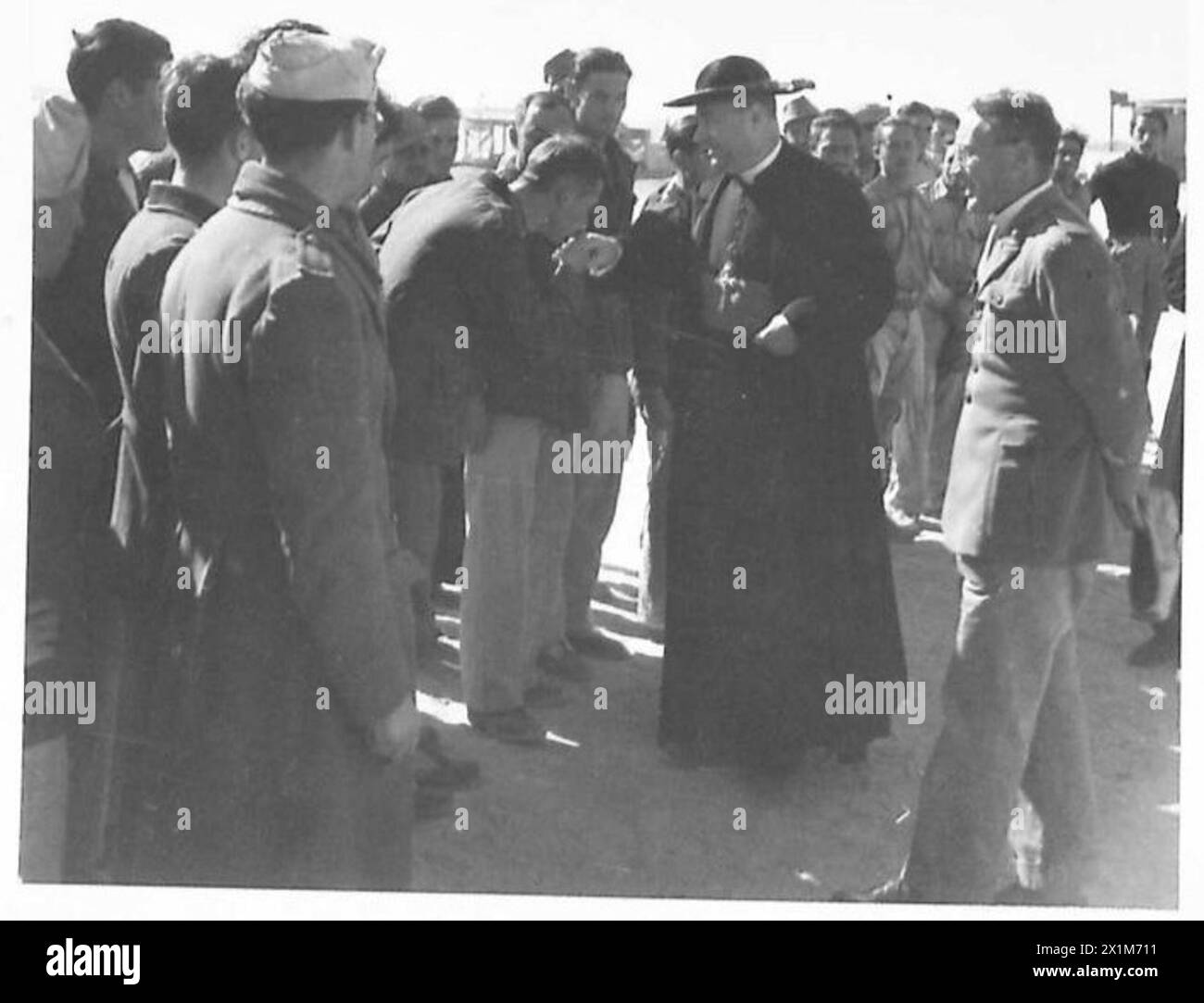 An Italian prisoner of war shows respect by kissing the Archbishop's ...