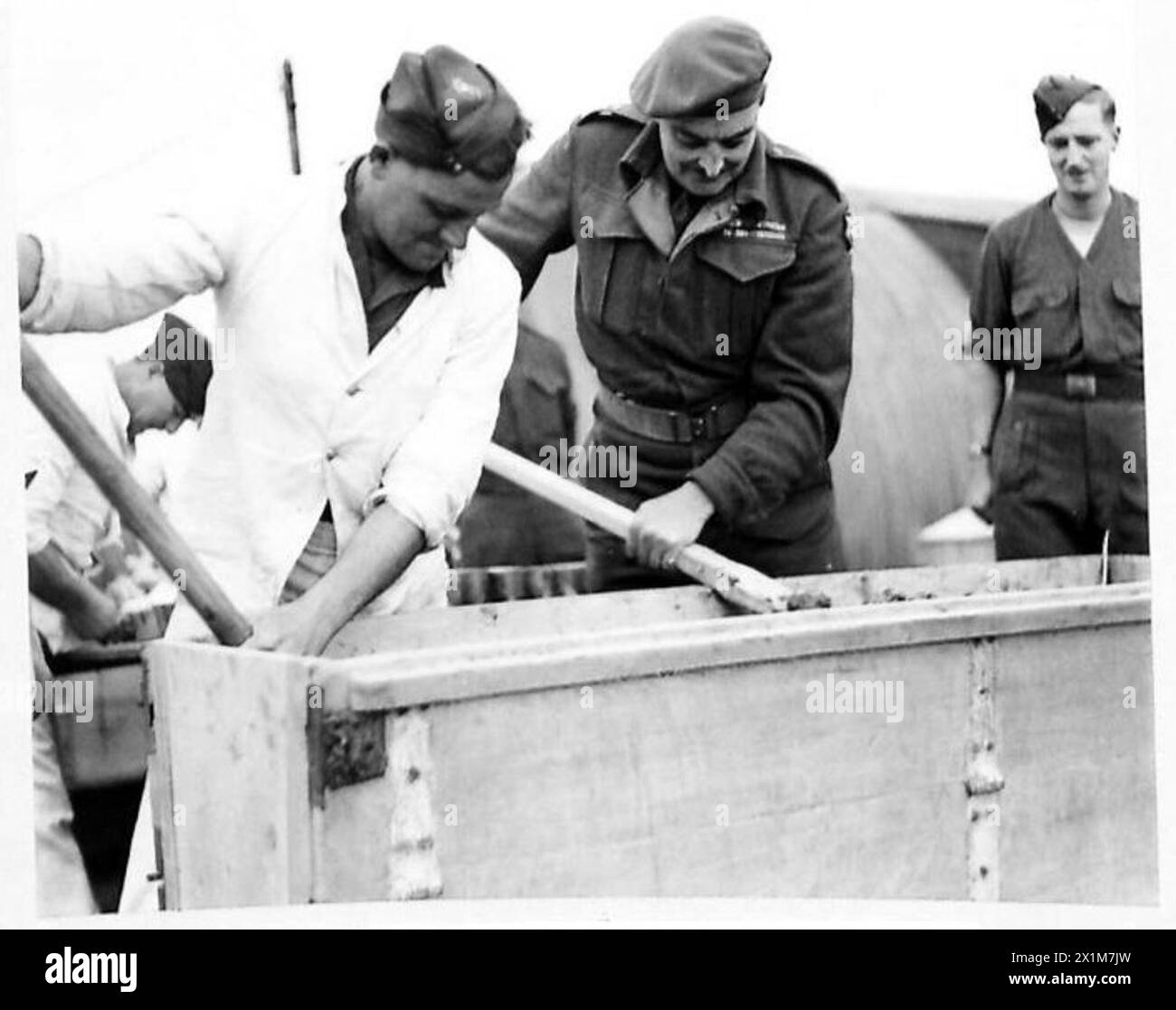 NORTH AFRICACHRISTMAS PUDDINGS FOR THE TROOPS - Brigadier Hinde having his 'lucky stir', British Army Stock Photo