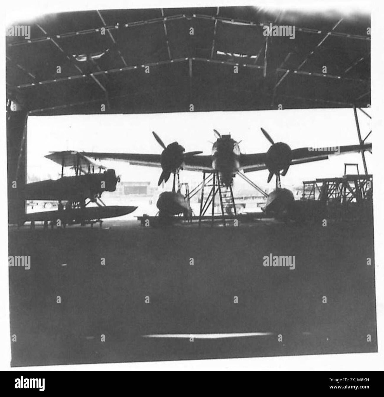 THE CAPTURED BASE OF AUGUSTA - Two Italian Fiat seaplanes in one of the hangars , British Army Stock Photo